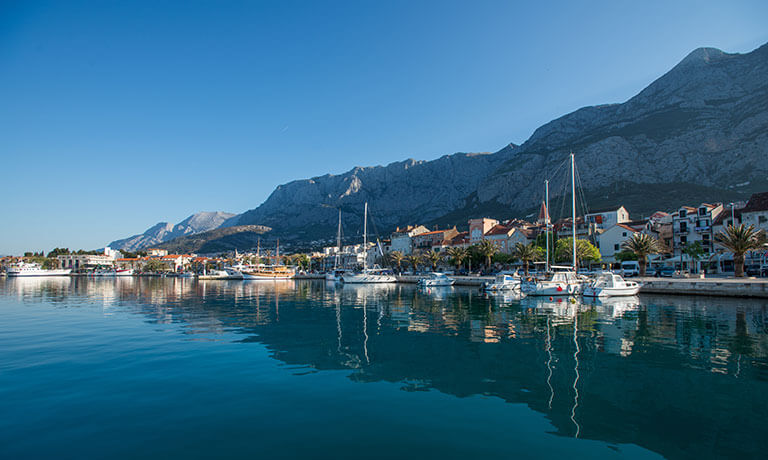 a body of water with boats and buildings along it